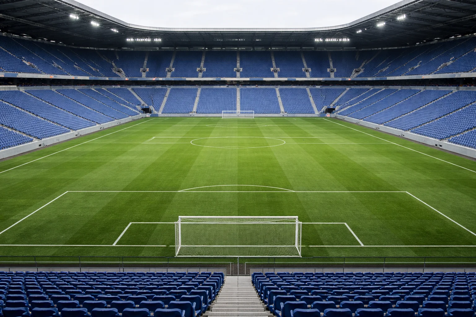 Empty football stadium with no spectators during a professional match, showing all empty seats