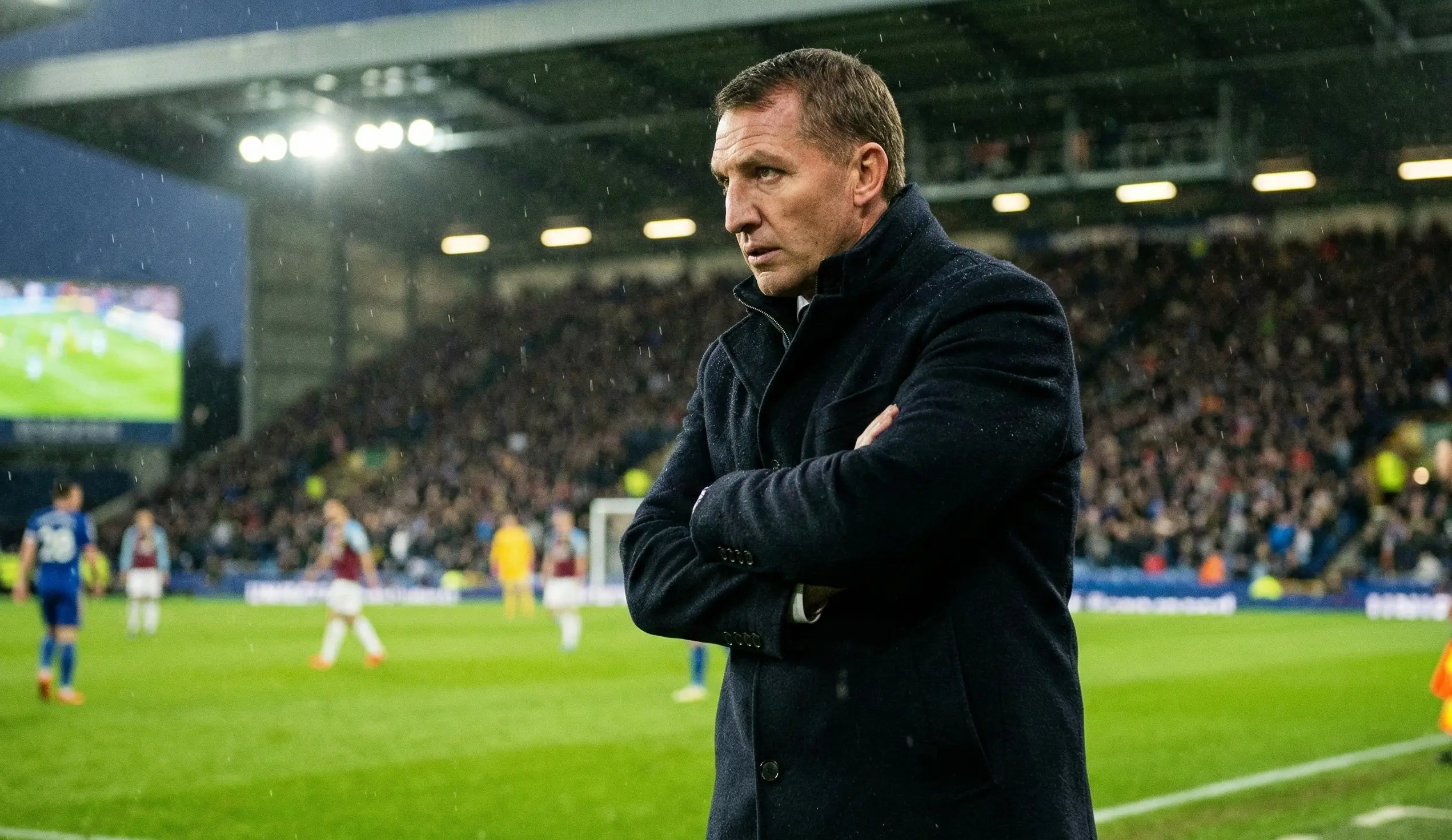 Football manager on the sideline observing the match with intense concentration