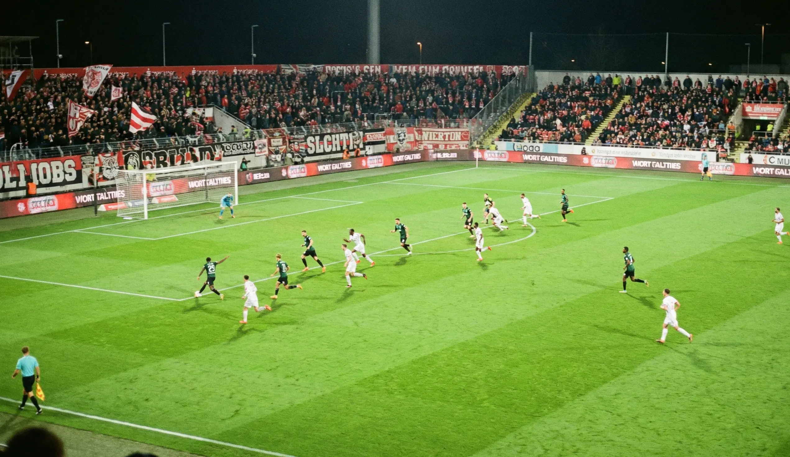 Two football teams in attacking formation during an open, end-to-end match